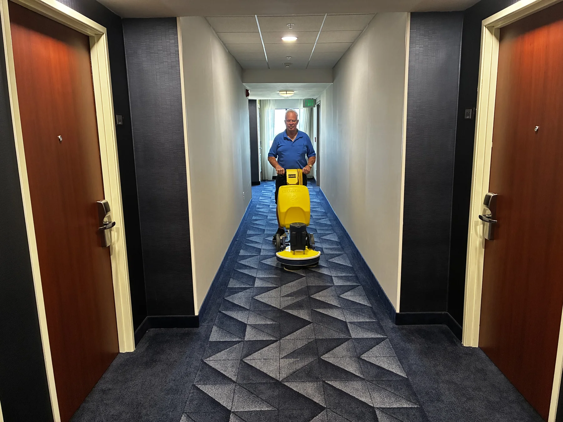 Commercial encapsulation carpet cleaning in a hallway with Cimex equipment by Great Western Carpet Care